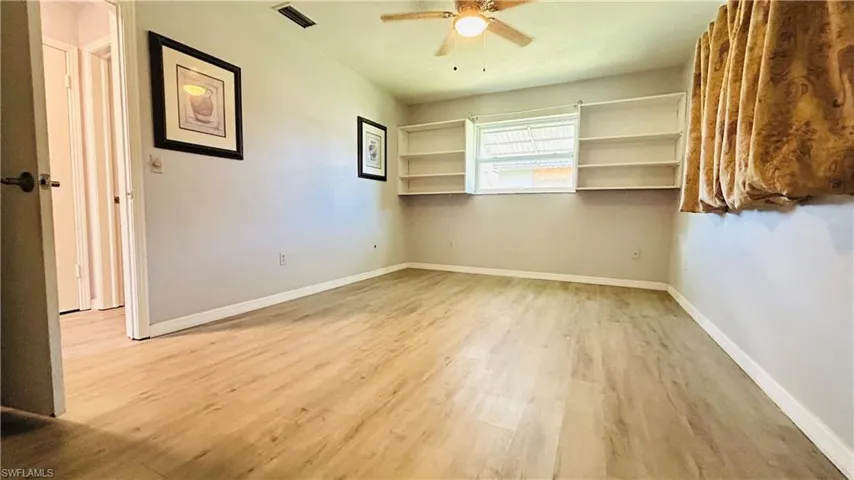 Unfurnished room featuring hardwood / wood-style floors and ceiling fan