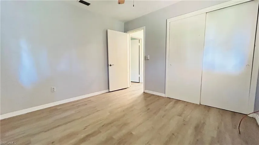 Unfurnished bedroom with a closet and light hardwood / wood-style floors