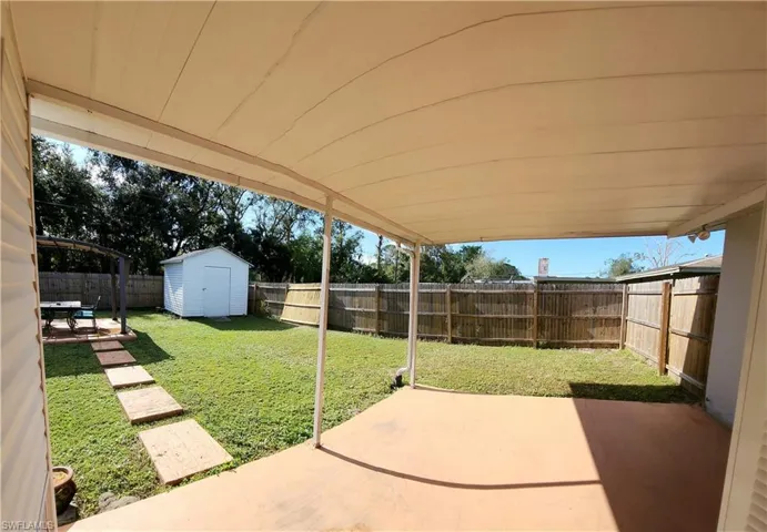 View of patio featuring a shed