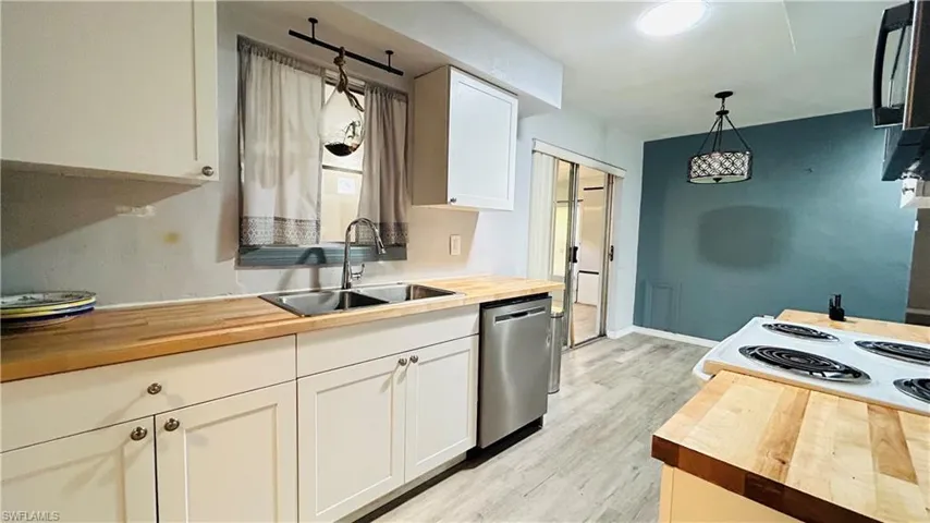 Bathroom with vanity, a shower with shower curtain, toilet, tasteful backsplash, and wood-type flooring