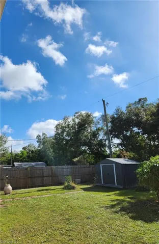 View of yard featuring a storage unit