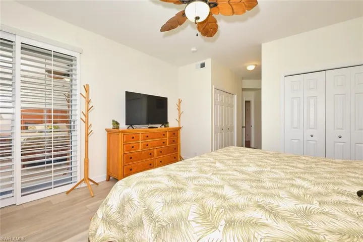 Bedroom with light wood finished floors and a ceiling fan