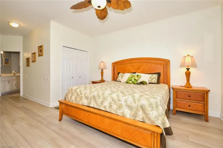 Bedroom featuring light wood-style flooring, a closet, baseboards, and ceiling fan
