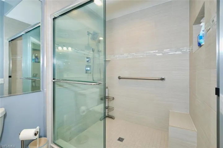 Full bathroom with toilet and a shower stall