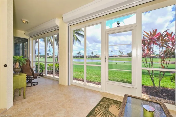 Sunroom / solarium featuring a water view, tile patterned flooring, and healthy amount of natural light
