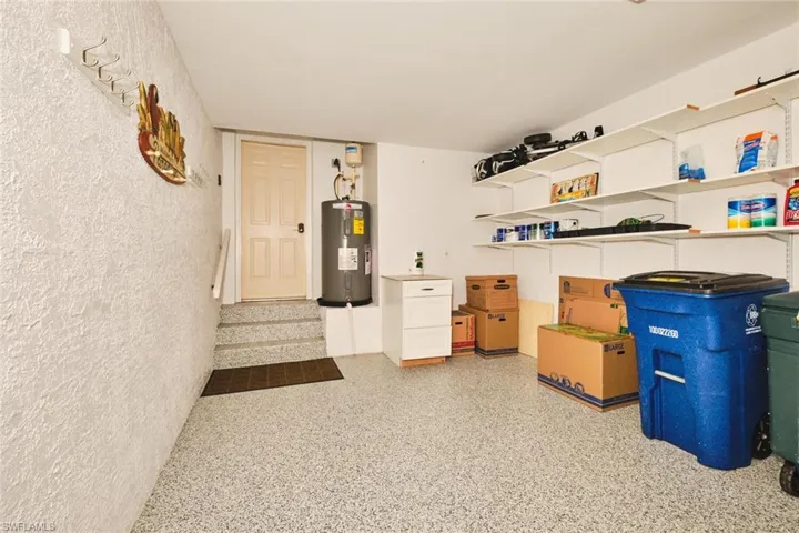 Storage room featuring water heater