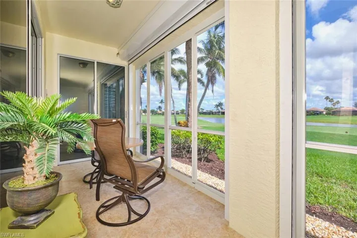 Sunroom / solarium featuring a water view and healthy amount of natural light