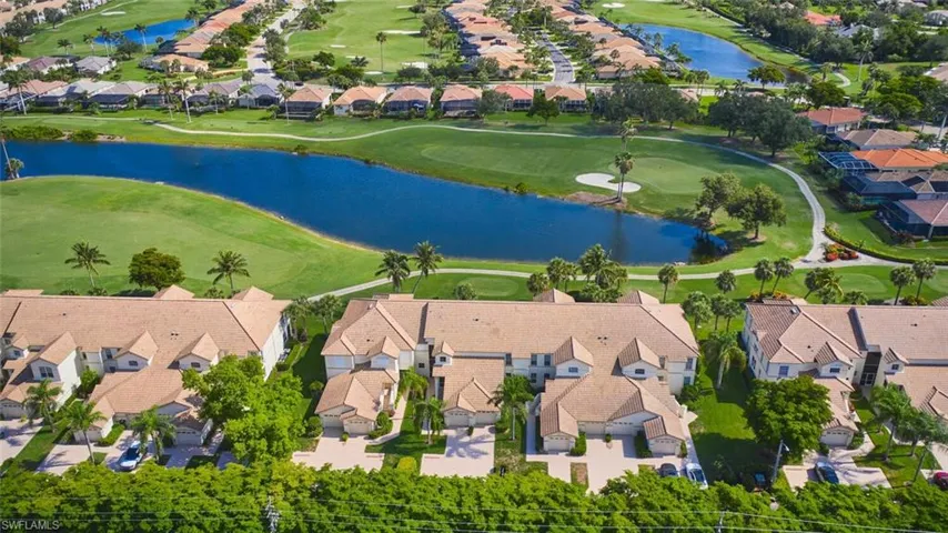 Aerial overview of property's location featuring nearby suburban area, a golf course, and a large body of water