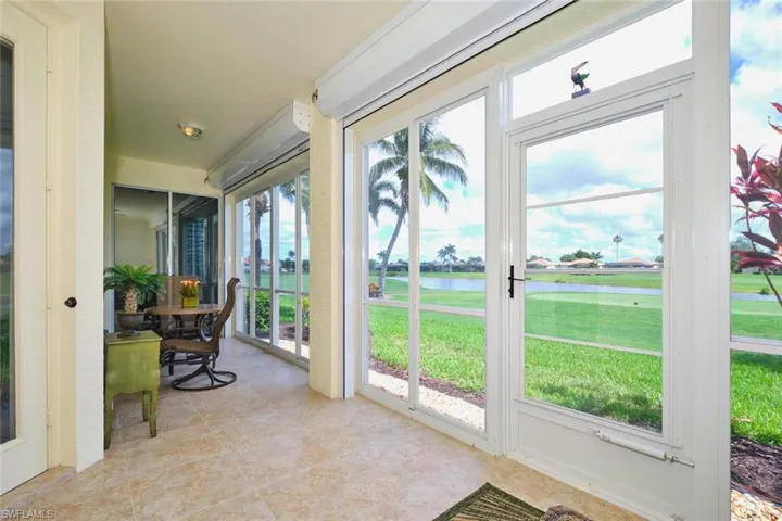 Sunroom featuring a water view and tile patterned flooring