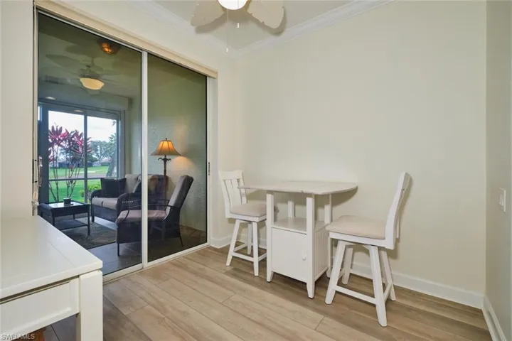 Dining space featuring ceiling fan, ornamental molding, baseboards, and light wood-type flooring