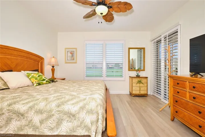 Bedroom featuring light wood-type flooring, ceiling fan, and baseboards