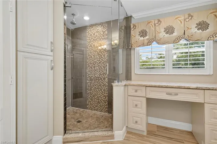Bathroom featuring a stall shower, light wood-type flooring, and recessed lighting