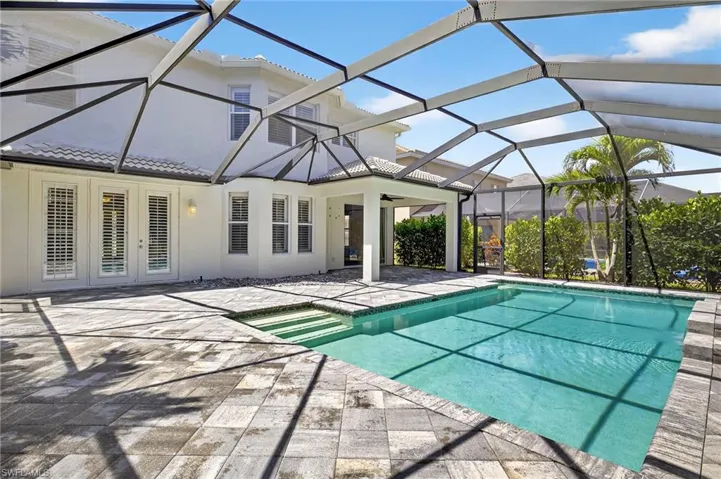 Outdoor pool featuring a sunroom, a patio area, a ceiling fan, and a lanai