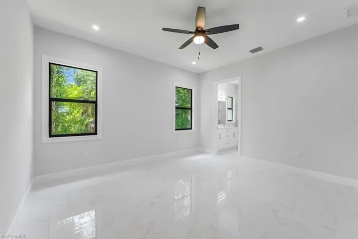 Tiled empty room with ceiling fan