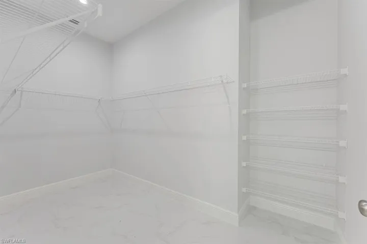 Walk in closet with tile patterned flooring