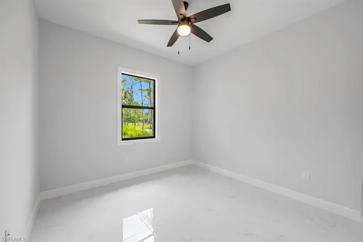 Spare room with ceiling fan