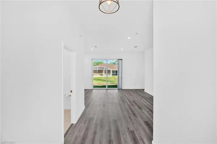 Corridor with light wood-style flooring and recessed lighting
