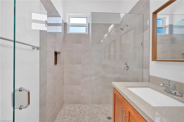 Bathroom with a shower stall and vanity