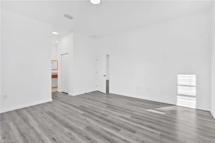 Empty room featuring light wood-style floors and recessed lighting