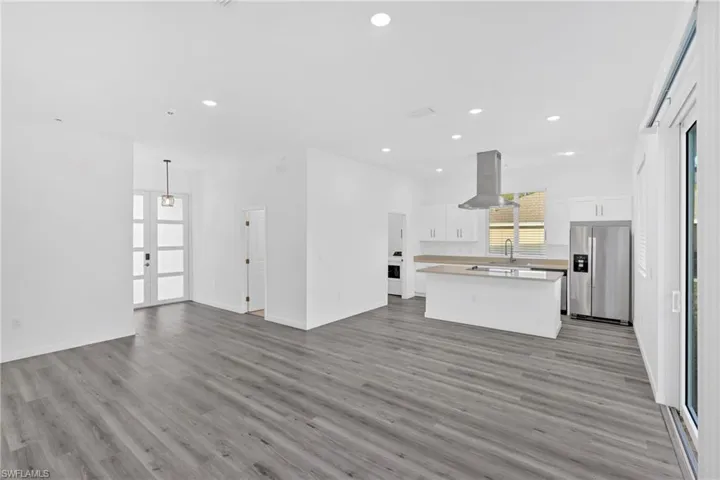 Unfurnished living room with light wood-style floors and recessed lighting