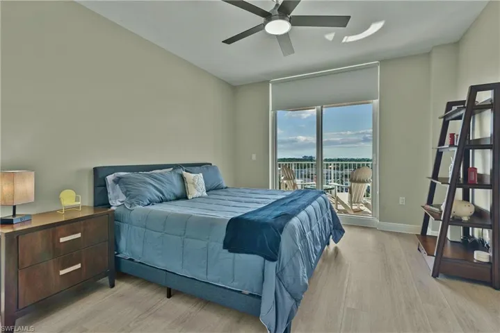 Bedroom #2 with ceiling fan, light wood-type flooring, and access to outside