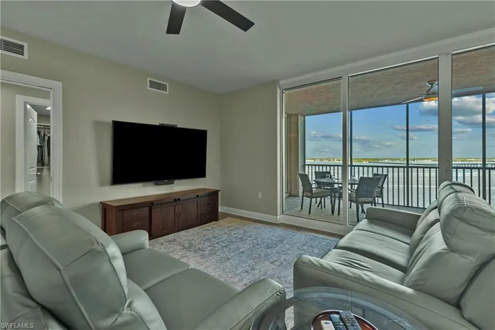 Living room with ceiling fan and wood-type flooring