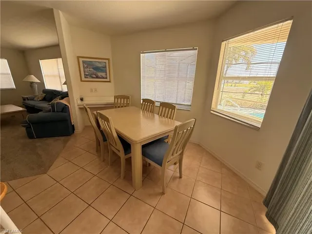 Dining room featuring light tile patterned floors and baseboards