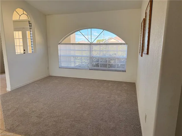 Spare room with light colored carpet