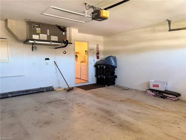 Garage with washer and dryer and a garage door opener