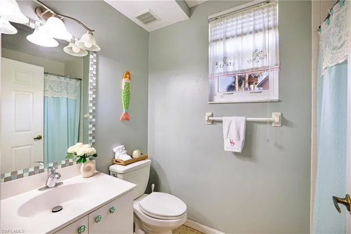 Full bath featuring vanity and a shower with curtain