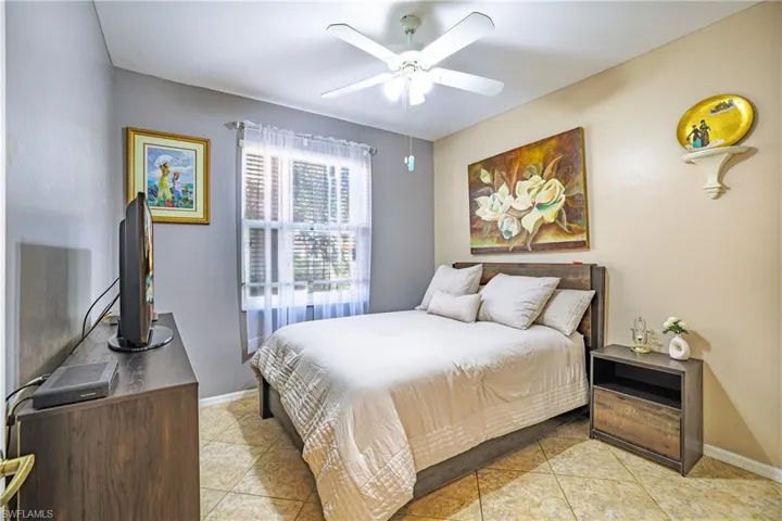 Bedroom featuring ceiling fan and light tile patterned flooring