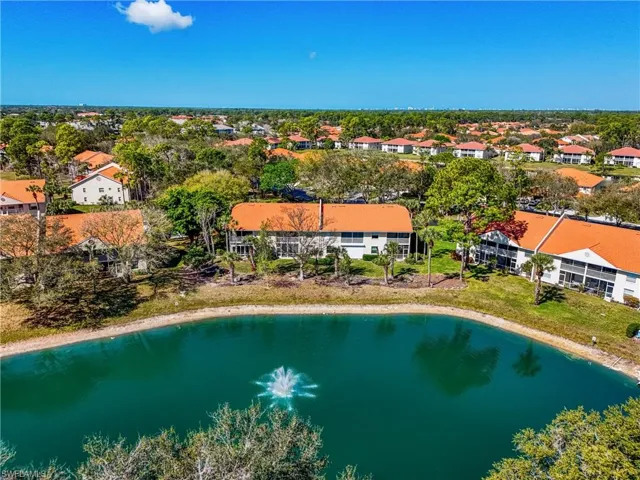 Aerial view of residential area featuring a nearby body of water