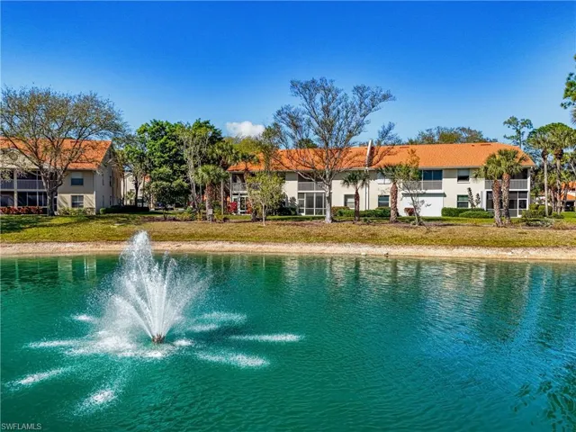 View of swimming pool featuring a water view and a lawn