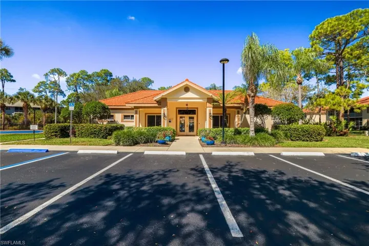 View of building exterior with uncovered parking