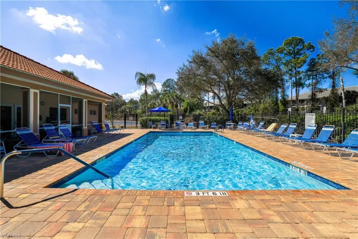 Community pool featuring a patio and a sunroom