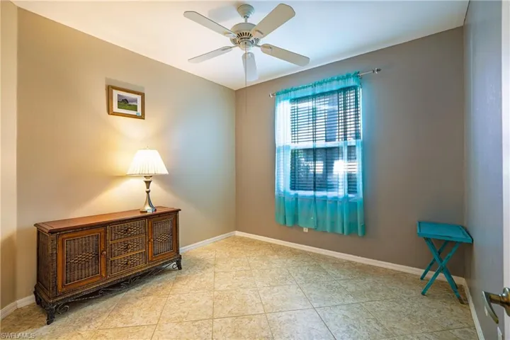 Empty room with ceiling fan and baseboards