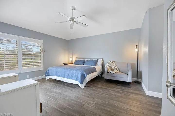 Bedroom featuring ceiling fan and dark hardwood / wood-style floors