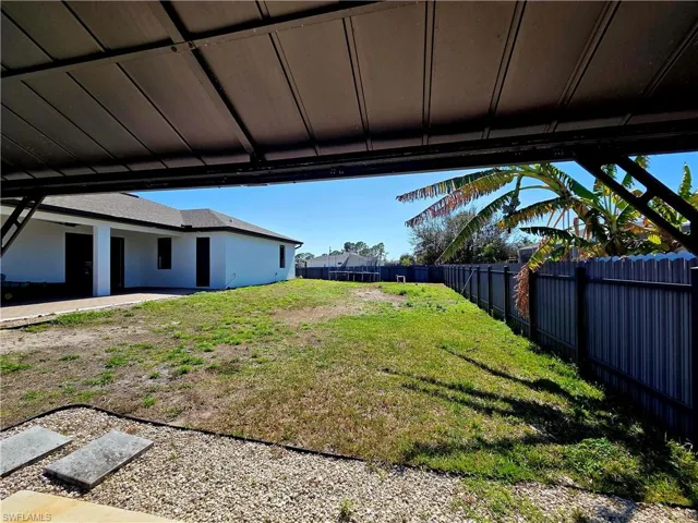 Fenced backyard with a patio