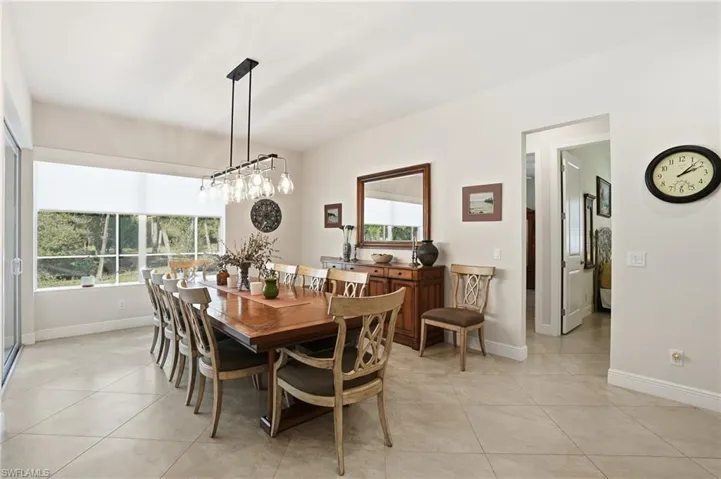 Dining room with baseboards and light tile patterned flooring