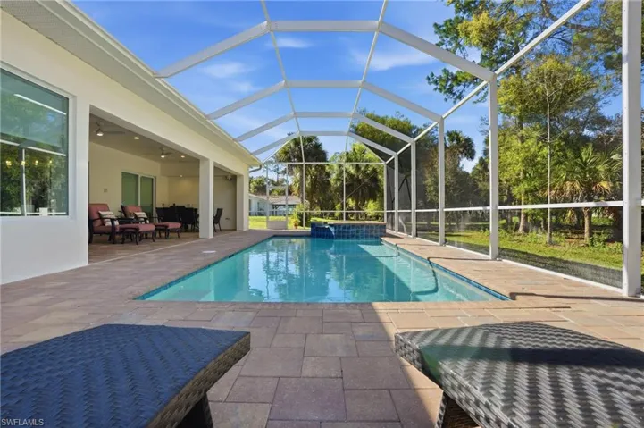 Pool and spa with extended screened pool cage and lanai