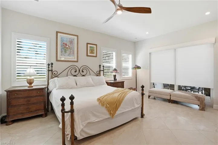 Bedroom with a ceiling fan, light tile patterned flooring, and recessed lighting