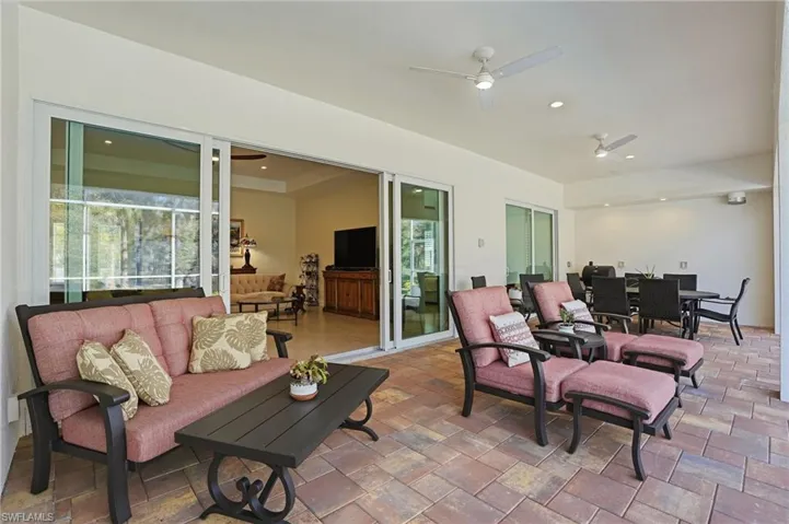 View of lanai with outdoor dining area, a ceiling fan, and an outdoor hangout area