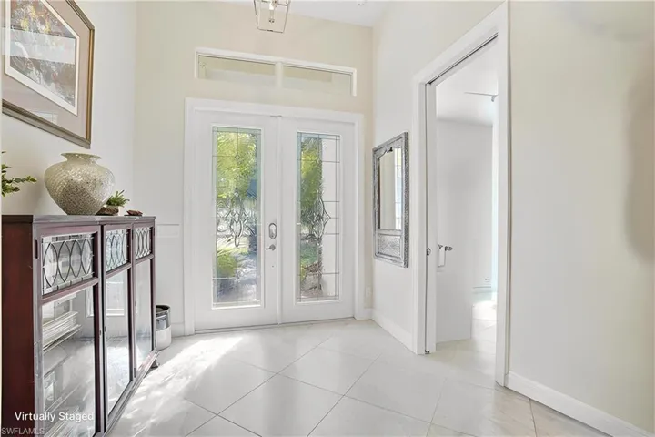 Foyer entrance with French doors allowing plenty of natural light through the lead glass doors and upper transom glass