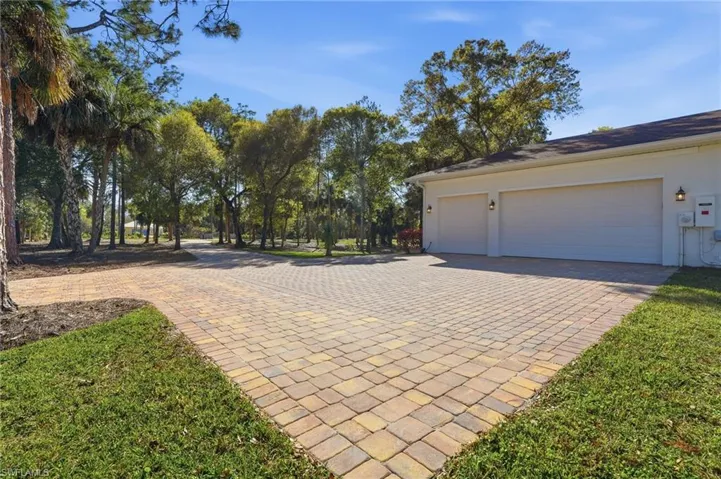 Wide paver driveway with extra parking area