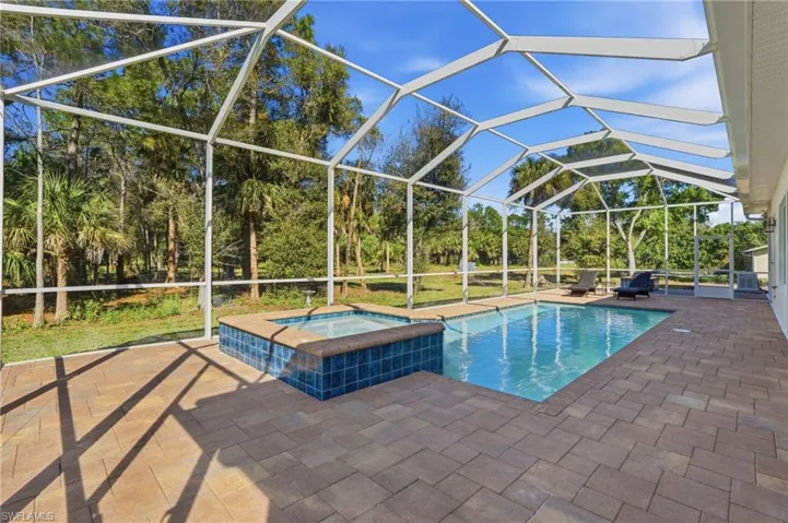 Pool and spa with extended screened pool cage and lanai