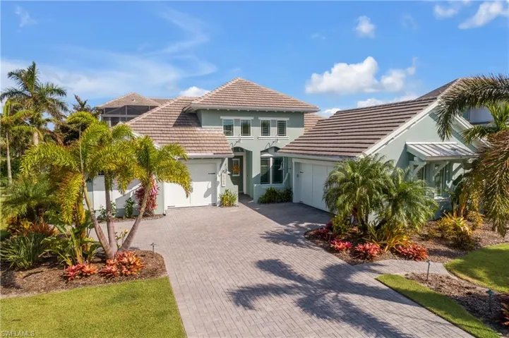 Front view of property featuring a 3 car garage and a 1 car. Note the beautiful landscaping.