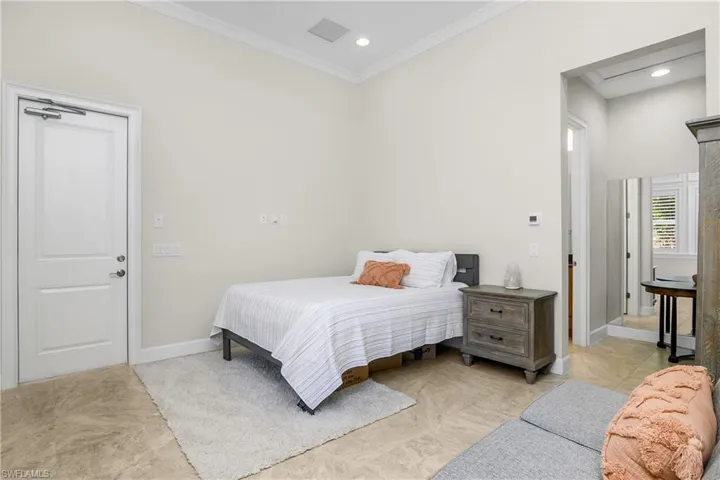 Ground floor casita Bedroom with ornamental molding, full bath. The entrance is Separate from the main house. Makes a great in-law space, no stairs! Nanny's suite. Teens!