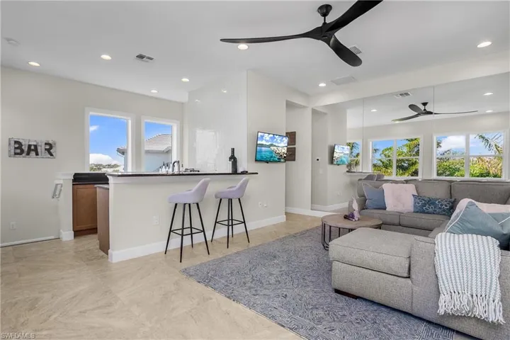 Second floor recreation room featuring a wealth of natural light and ceiling fan, beautiful views, sunsets.