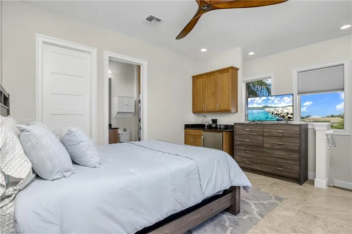 Second floor guest casita Bedroom featuring connected bathroom, stainless steel fridge, sink, and beautiful water views.