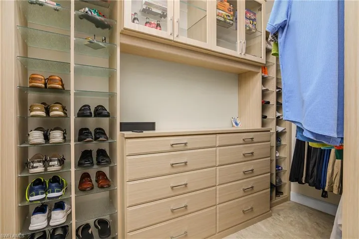 View of walk in closet. Built in cabinetry.